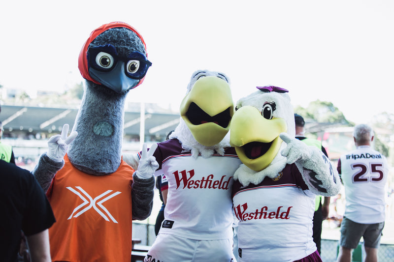 "VoltX Energy mascot Eddie posing with two Sea Eagles mascots ahead of the Sea Eagles vs Knights match at 4 Pines Park