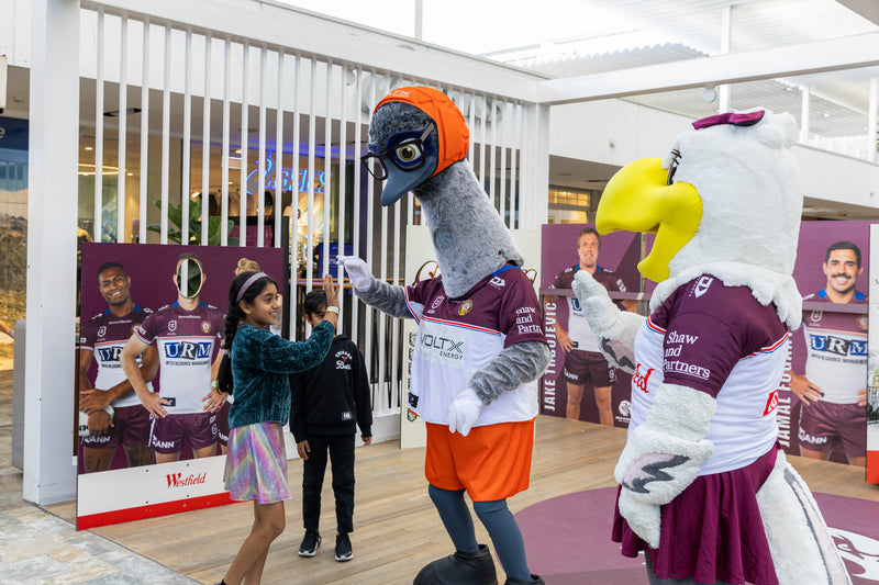 VoltX Energy mascot Eddie high-fiving young fans alongside a Sea Eagles mascot at a Westfield mall appearance