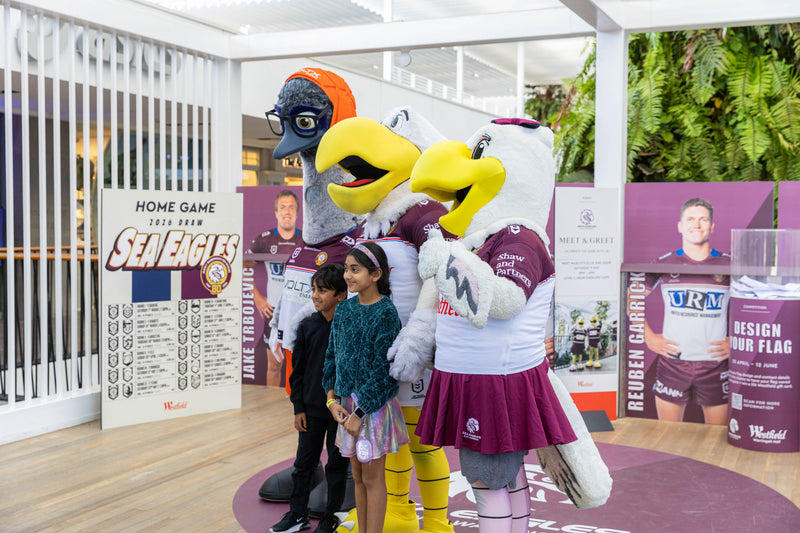 VoltX Energy mascot Eddie posing with two Sea Eagles mascots and young fans at a Westfield Warringah Mall meet and greet