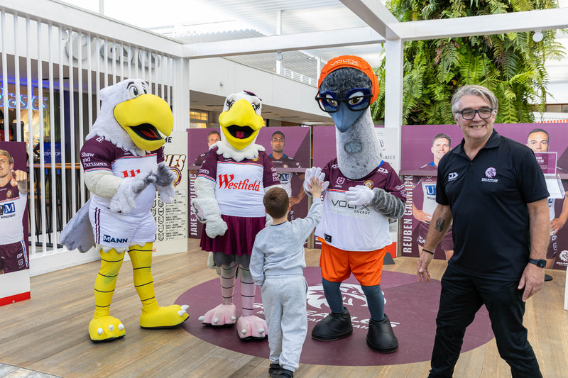 VoltX Energy mascot Eddie high-fiving a young fan alongside two Sea Eagles mascots at a Westfield Warringah Mall meet and greet